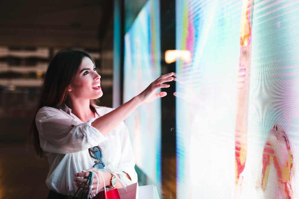 A woman amazed by an indoor led display